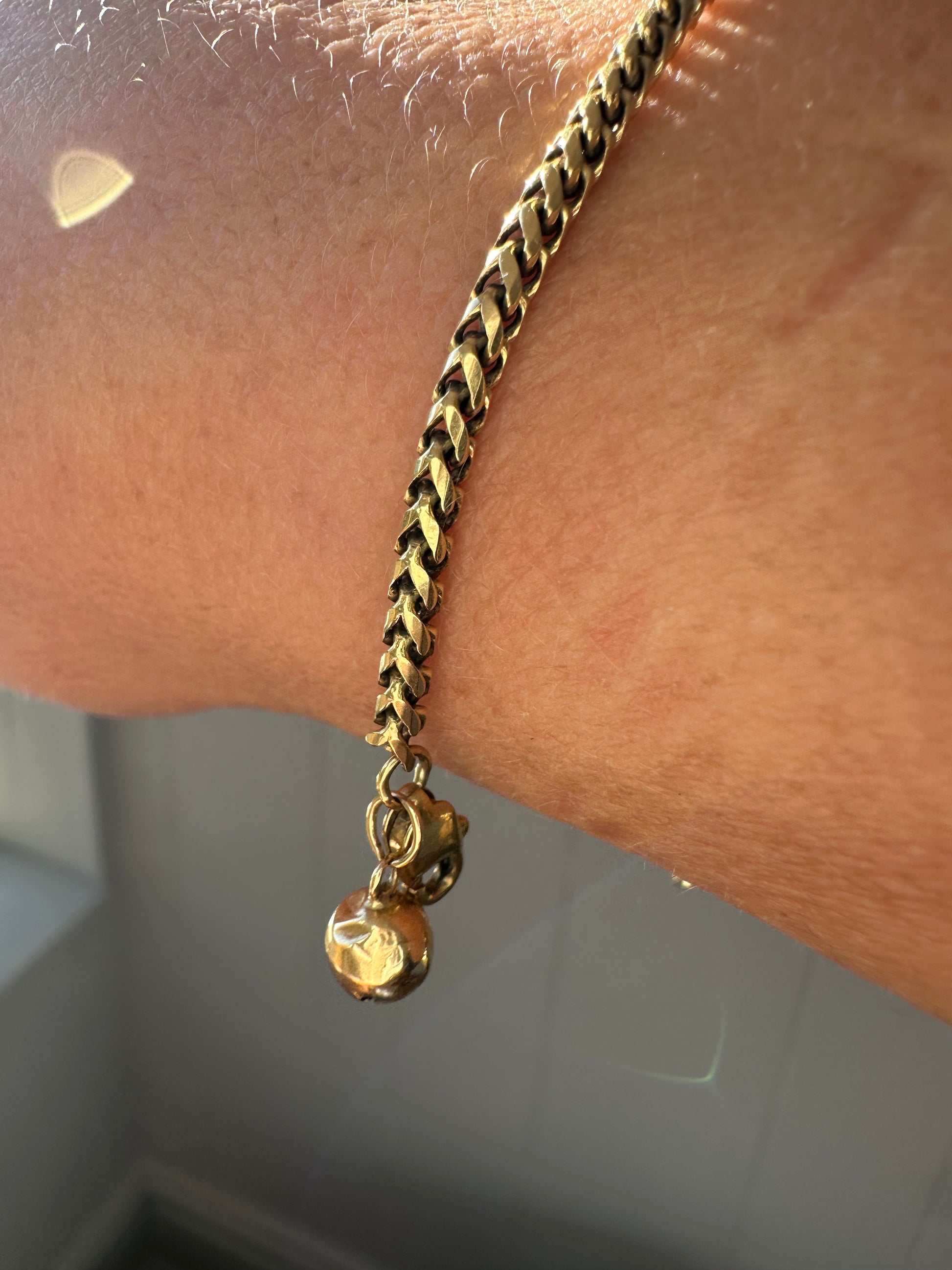 18k gold rounded wheat bracelet with jingle bell