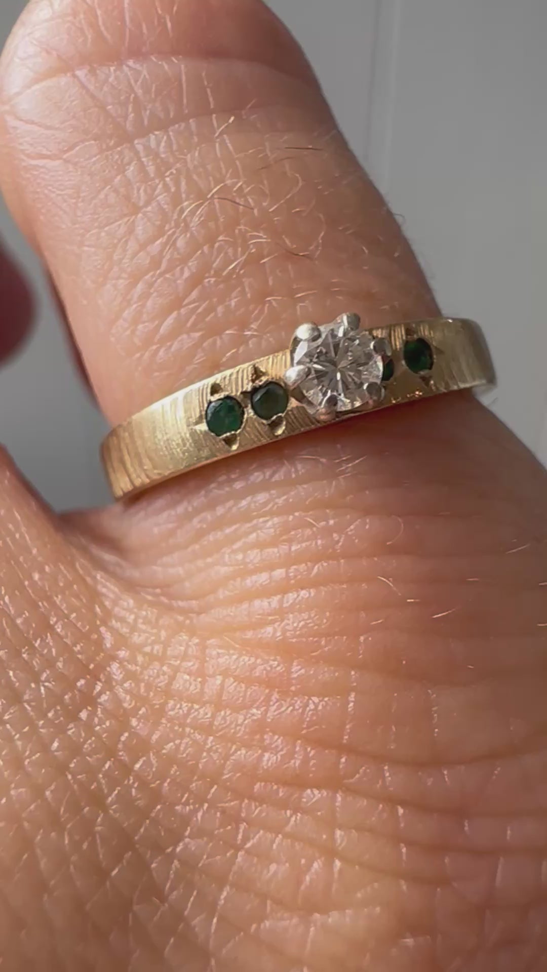 solitare diamond with emerald accents