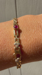 18k gold open bar link bracelet with ruby cabochon