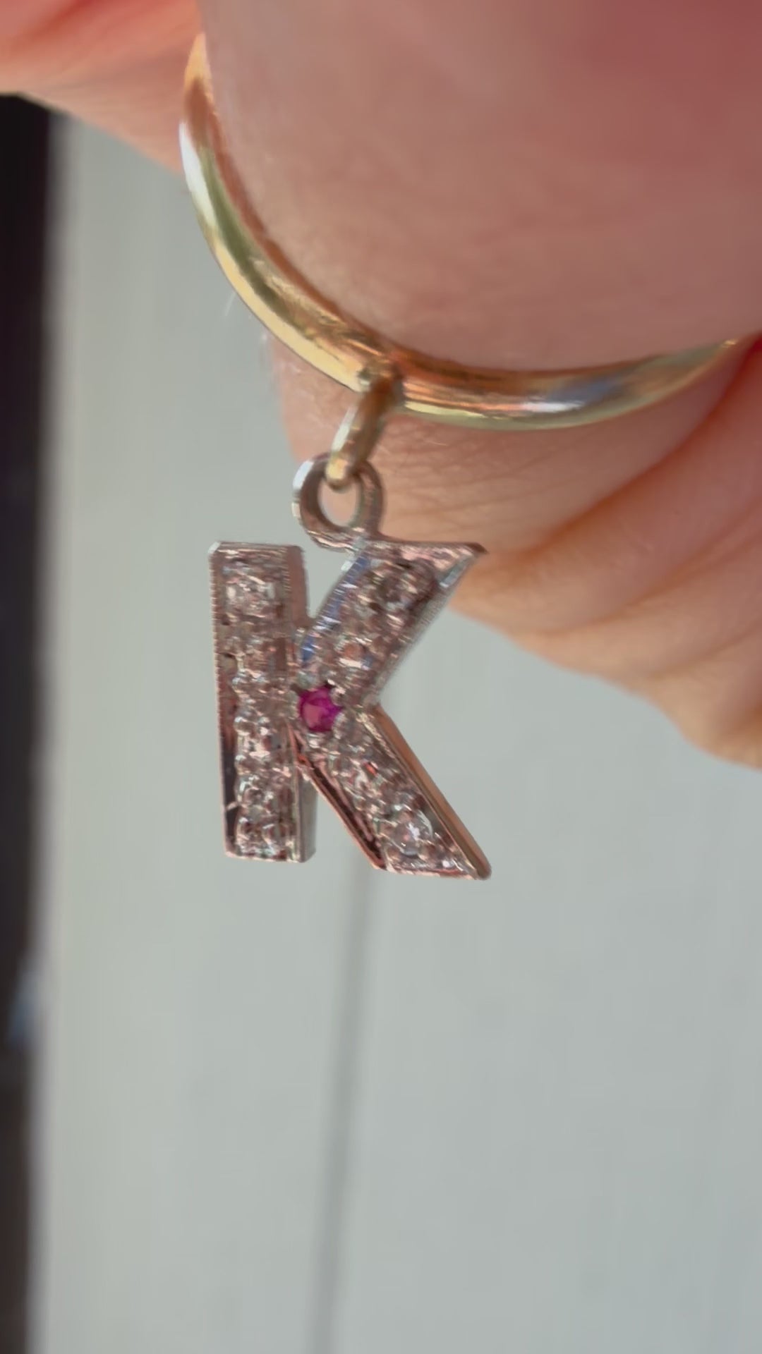 yellow gold donut with white gold diamond and ruby K charm