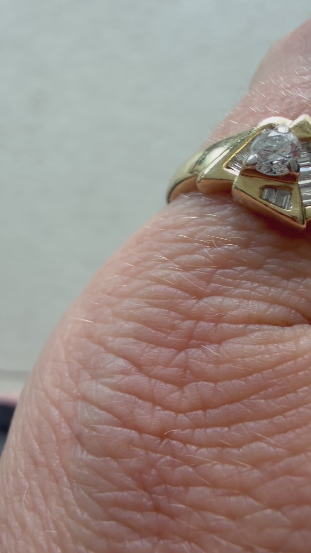 triangle ring with baguettes and round diamond