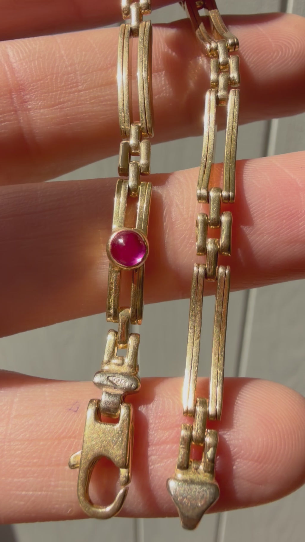 18k gold open bar link bracelet with ruby cabochon
